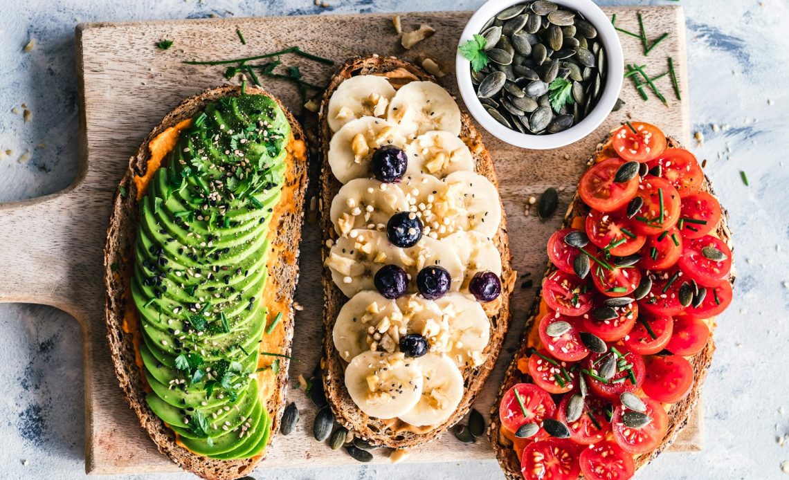 assorted fruits and vegetable on brown wooden chopping board