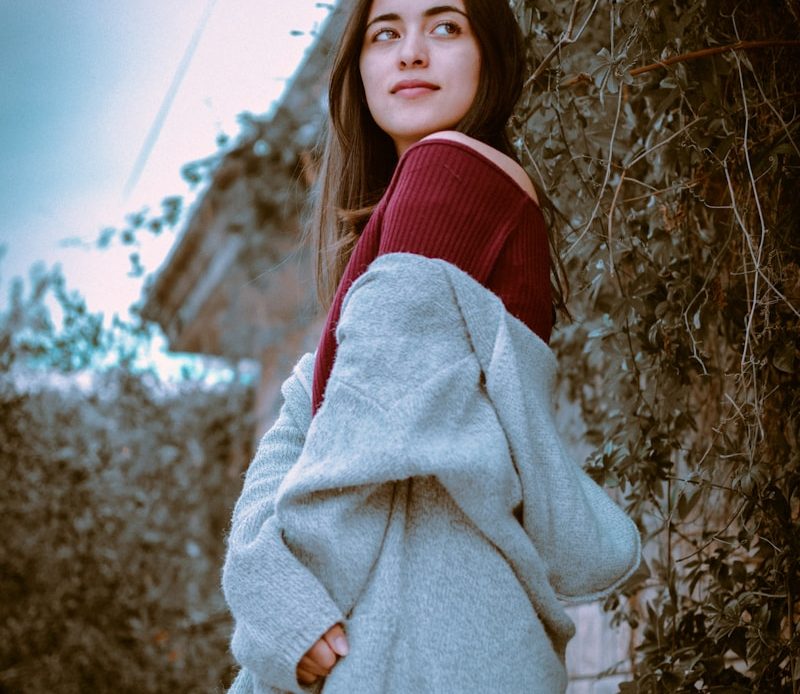 woman standing beside vine plant