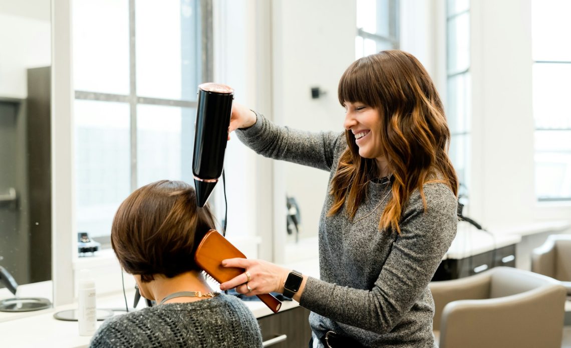 woman holding hair dryer