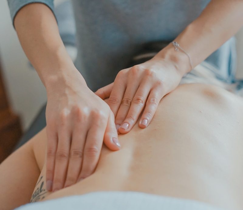 man massaging woman's body